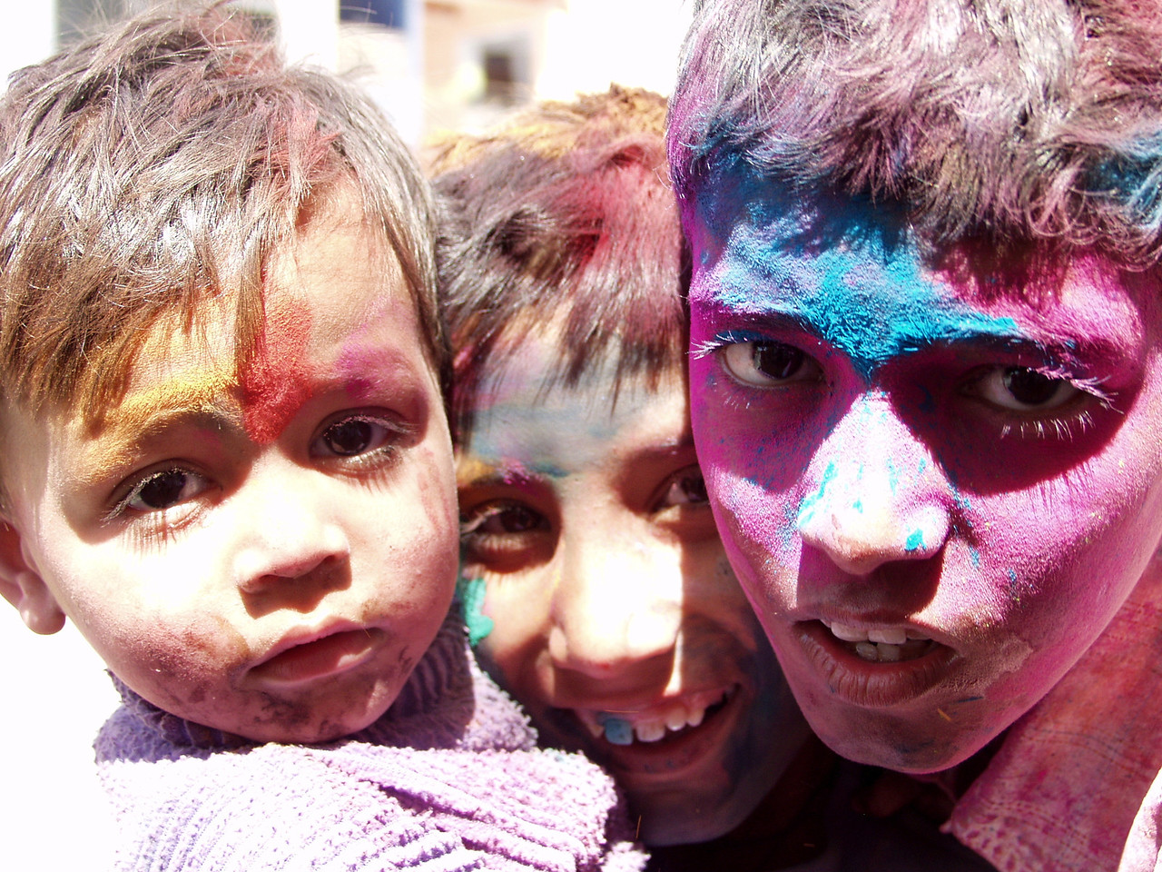 three young boys had a lot of fun on holi and are decked out in colors