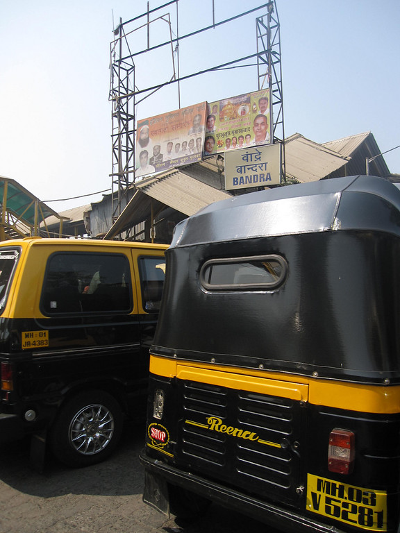 The black and yellow rickshaws buzz around mumbai. rickshaws in mumbai cultue