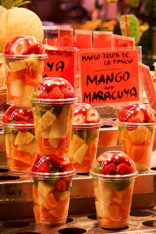 An array of fresh chopped fruit for sale in la Boqueria market in Barcelona, Spain.