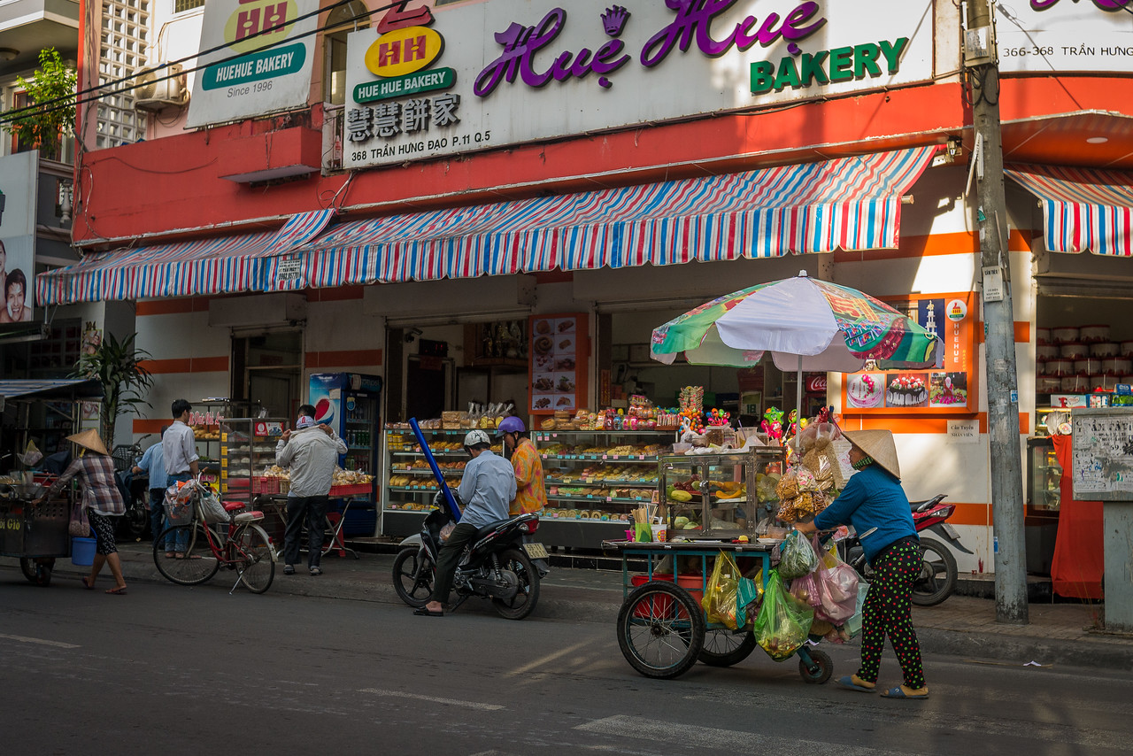 A vendor walks the streets in Cholon.