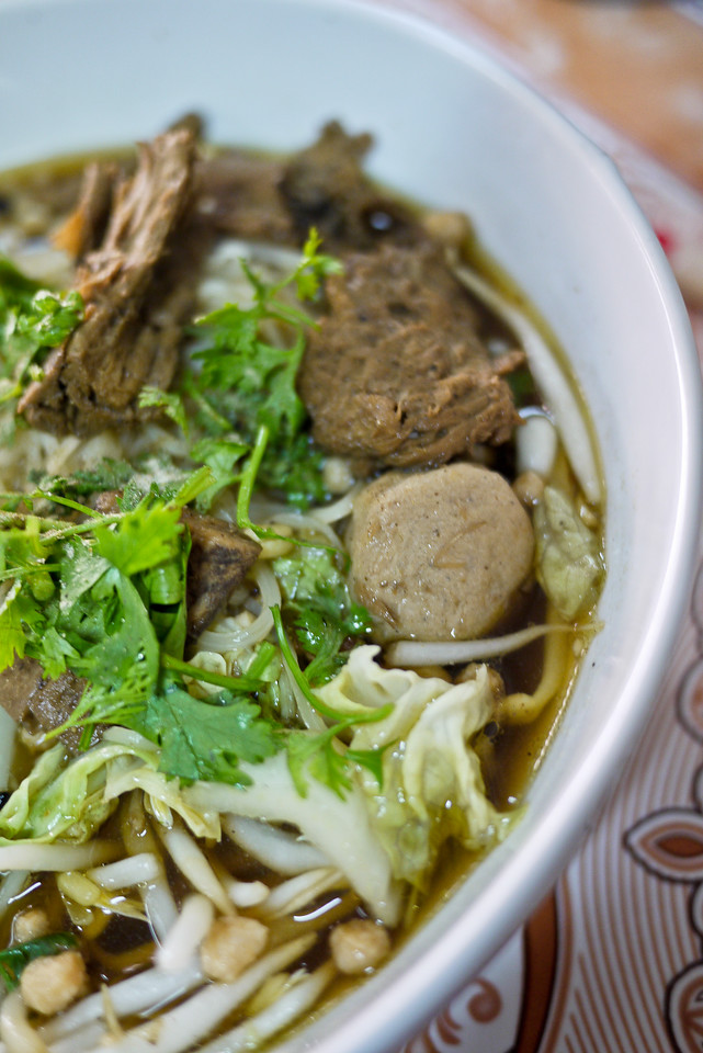 Steaming hot soup from with seitan and vegetables in a strong broth.