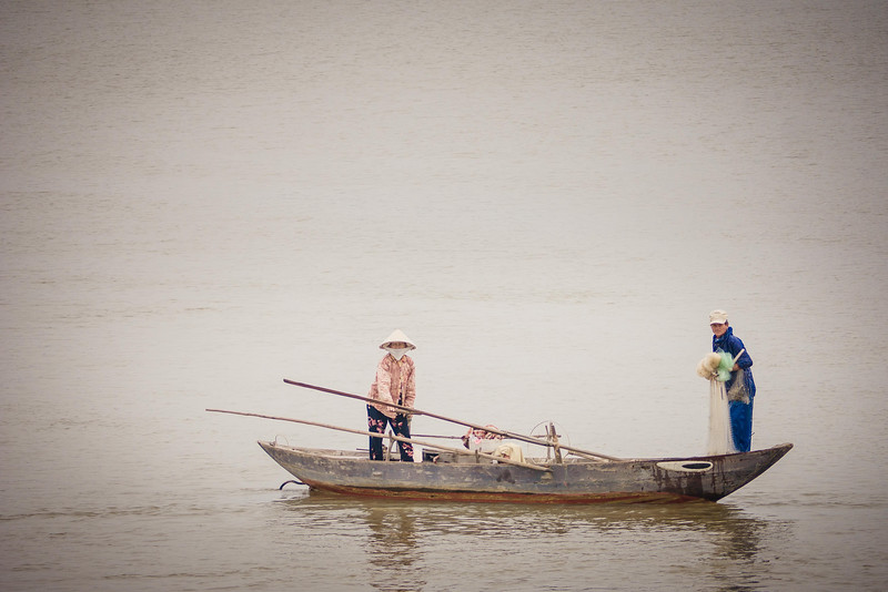 Fisherman prepare to cast their net on a rainy day bike ride around Hoi An. bike riding around outskirts of Hoi An.