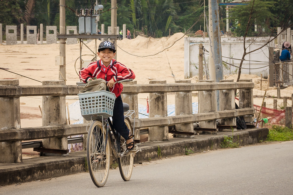 A school student smiles big on his way home from school. school student Vietnam travel
