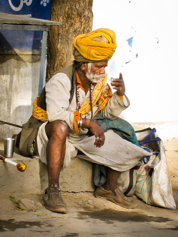 An Indian man sips hot chai tea on a warm day in Rajasthan. sipping chai tea