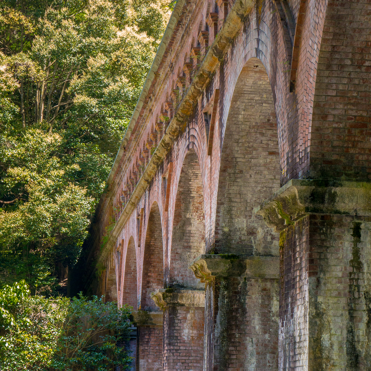 I loved this beautiful brick aqueduct at the Nanzen-ji temple in Kyoto. The aqueduct was a part of a canal system, and if you slip beyond the arches and all the way up the hill behind it, there is a tiny waterfall grotto. The cave has dozens of worn and old Buddha statues. Only one other tourist also ventured up the hill, and they disappeared quickly up the mountain on a longer hike, so I had the little piece of whispering forest all to myself. The aqueduct at Nanzen-ji Temple