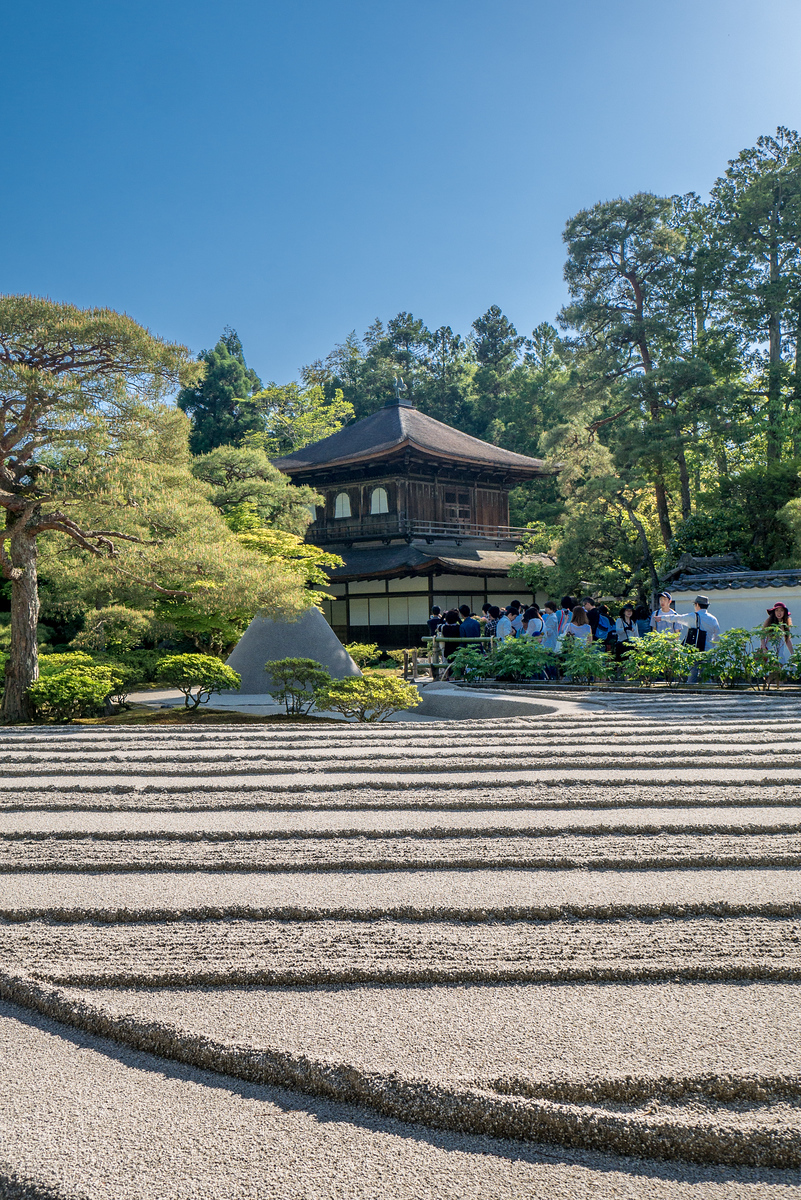 Ginkaku-ji Temple, also know as the Silver Pavilion has raked Zen sand garden (a large scale version of those tiny ones made for desks). The temple in this picture was originally intended to have silver foil laid over the outside, but in the 1400s the owner died before completing the plans, so it instead sits against the skyline and half-naked beauty. Ginkaku-ji Temple sand garden