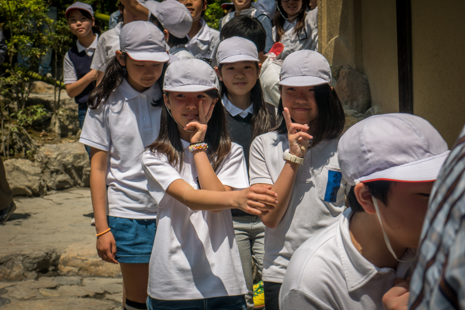 A sly peace sign there from one of the girls. Kyoto's Golden Temple, Kinkaku-ji