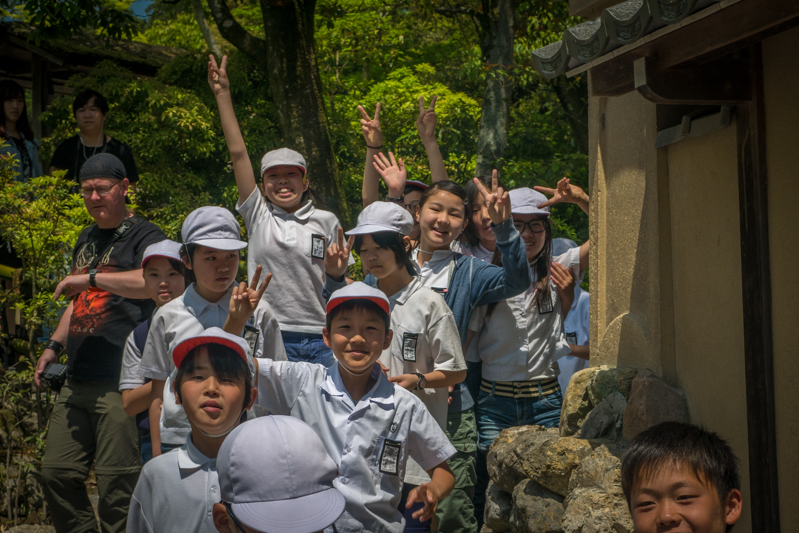 School kids jump to say hi at Kyoto's Golden Temple, Kinkaku-ji. school kids at Kyoto's Golden Temple, Kinkaku-ji