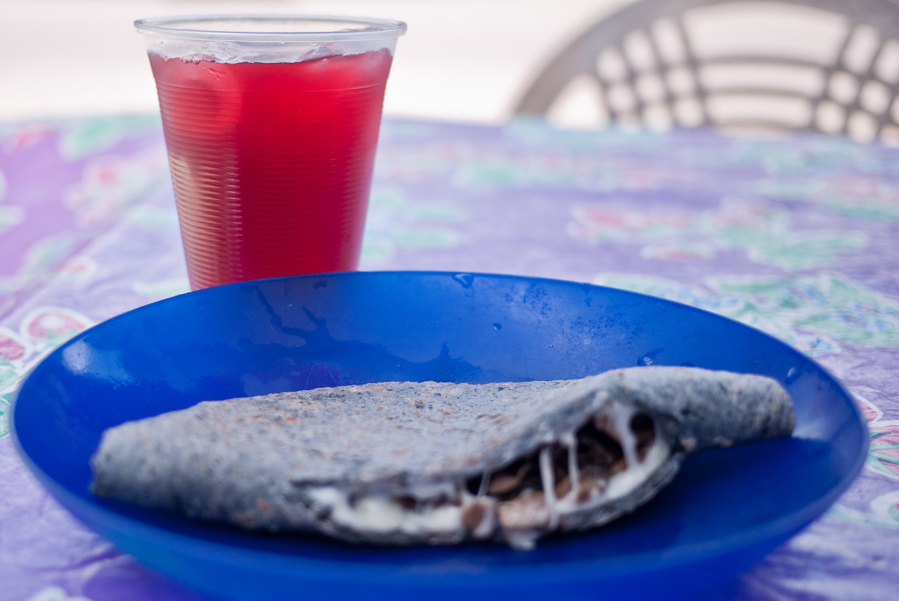 a mushroom and cheese quesadilla made with blue corn tortillas and served with agua fresca