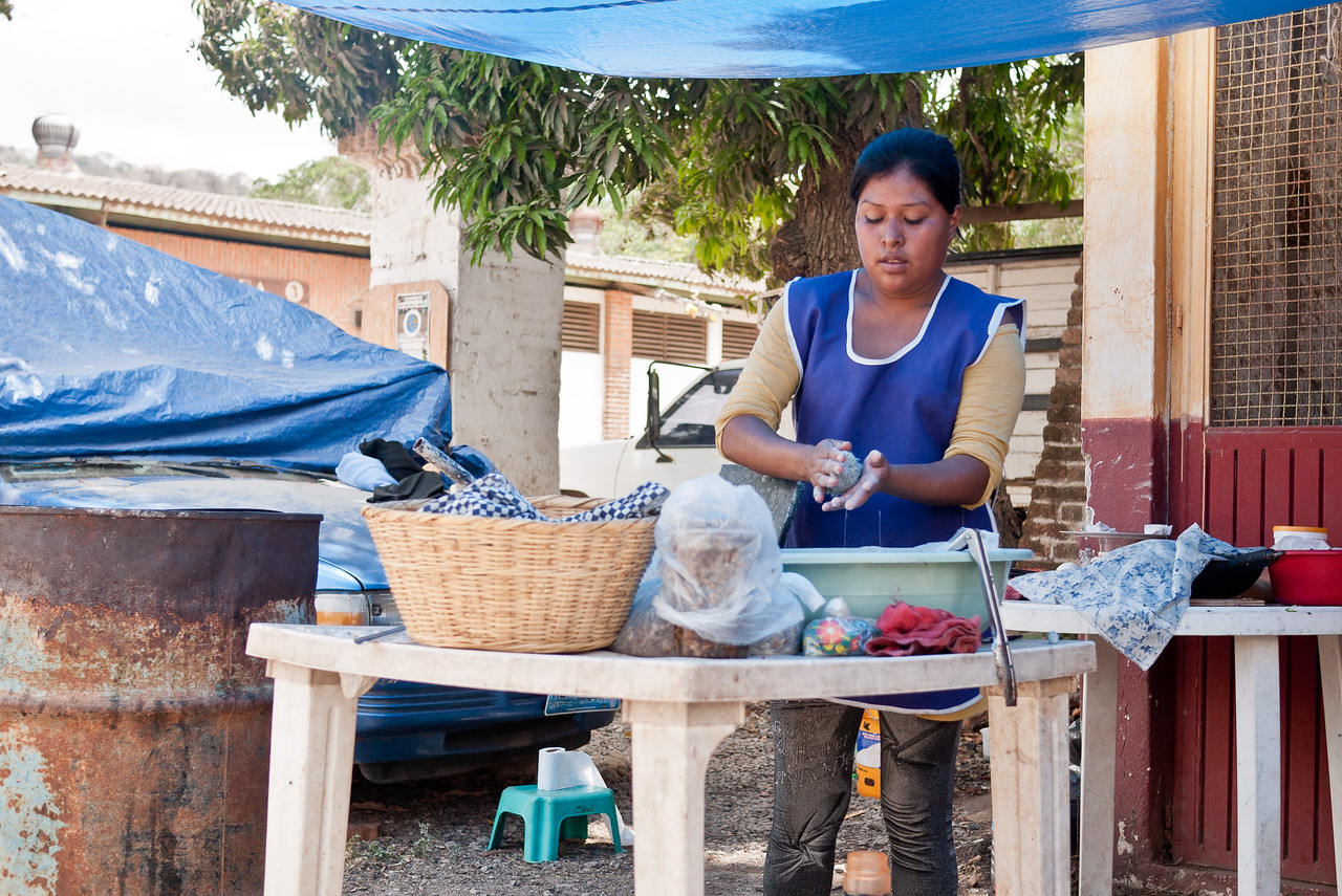 Learning how to make blue corn tortillas in from a street food vendor in Mexico.