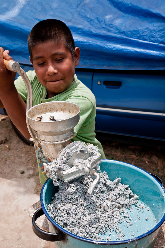 Learning how to make blue corn tortillas in from a street food vendor in Mexico.