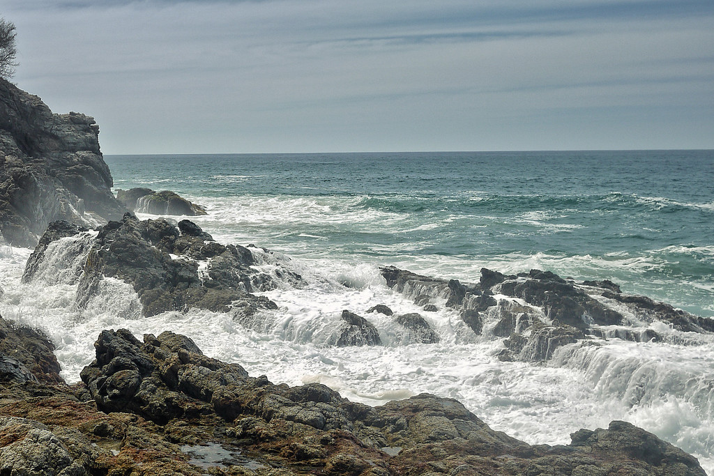 Waters crashing over the rocks a mud beach in near San Pancho, Mexico
