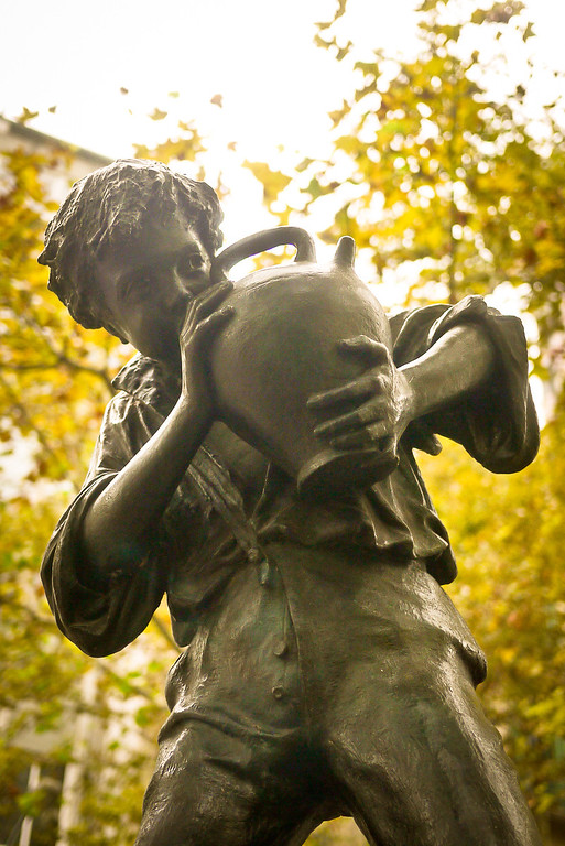 A statue of a boy drinking from a jug in Barcelona, Spain.