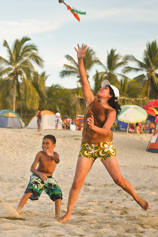 A family plays on the beach." title="A family plays on the beach.