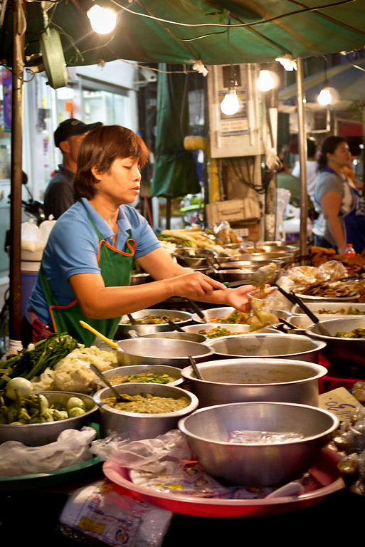 An array of cooked meals are ready to be served and eaten at the Chiang Mai Gate market in Thailand.