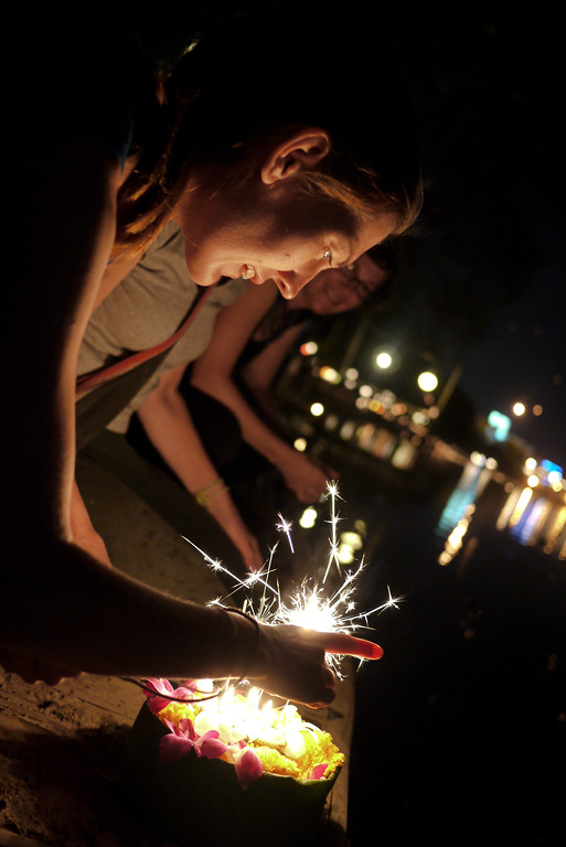 Lighting the sparklers and incense during Loy Krathong in Chiang Mai, Thailand