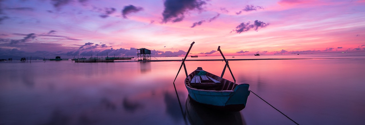 stunning pink sunset over the water while traveling in Vietnam