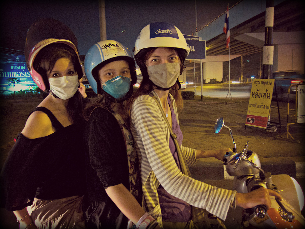 Three women to a motorbike in Chiang Mai thailand as I drive a friend and my niece around