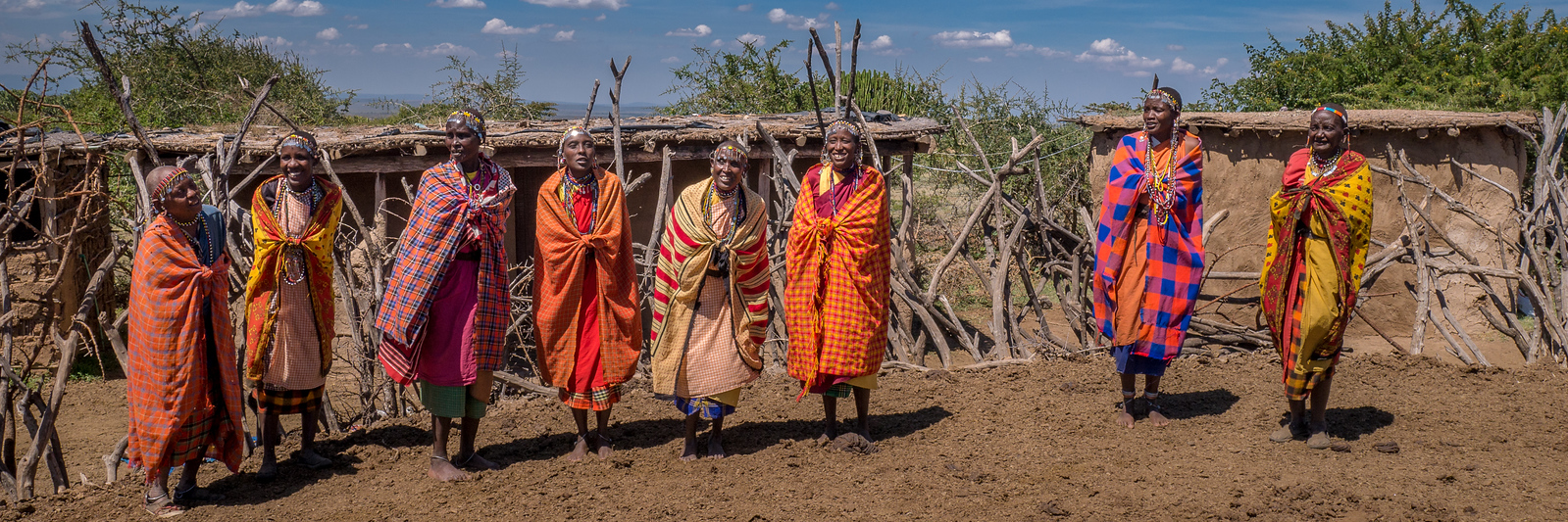 The women at the Women's Village greet us with a traditional song and dance to welcome us to their home. They are all wearing a traditional shuka, which is worn by both sexes and is a part of their everyday dress. maasai experience kenya women in shukas
