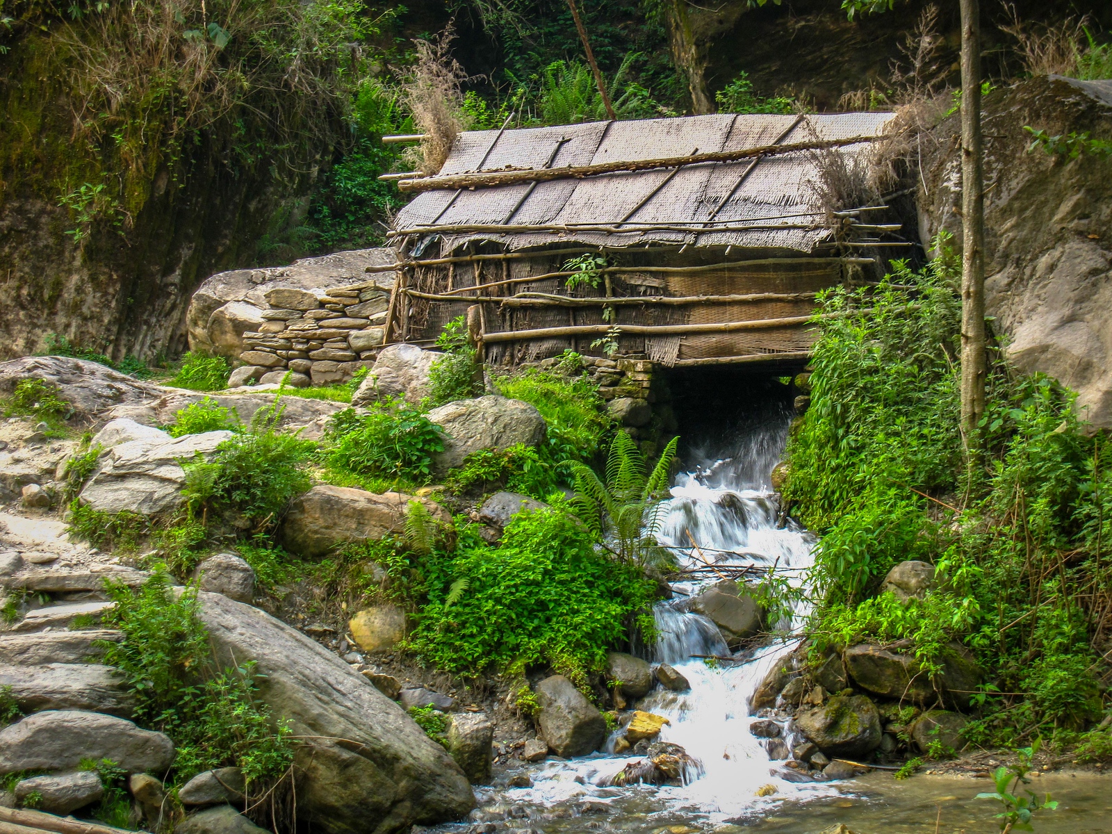 One of the prettiest spots on the hike was this house built over a stream. thatched roof houses in the annapurna circuit