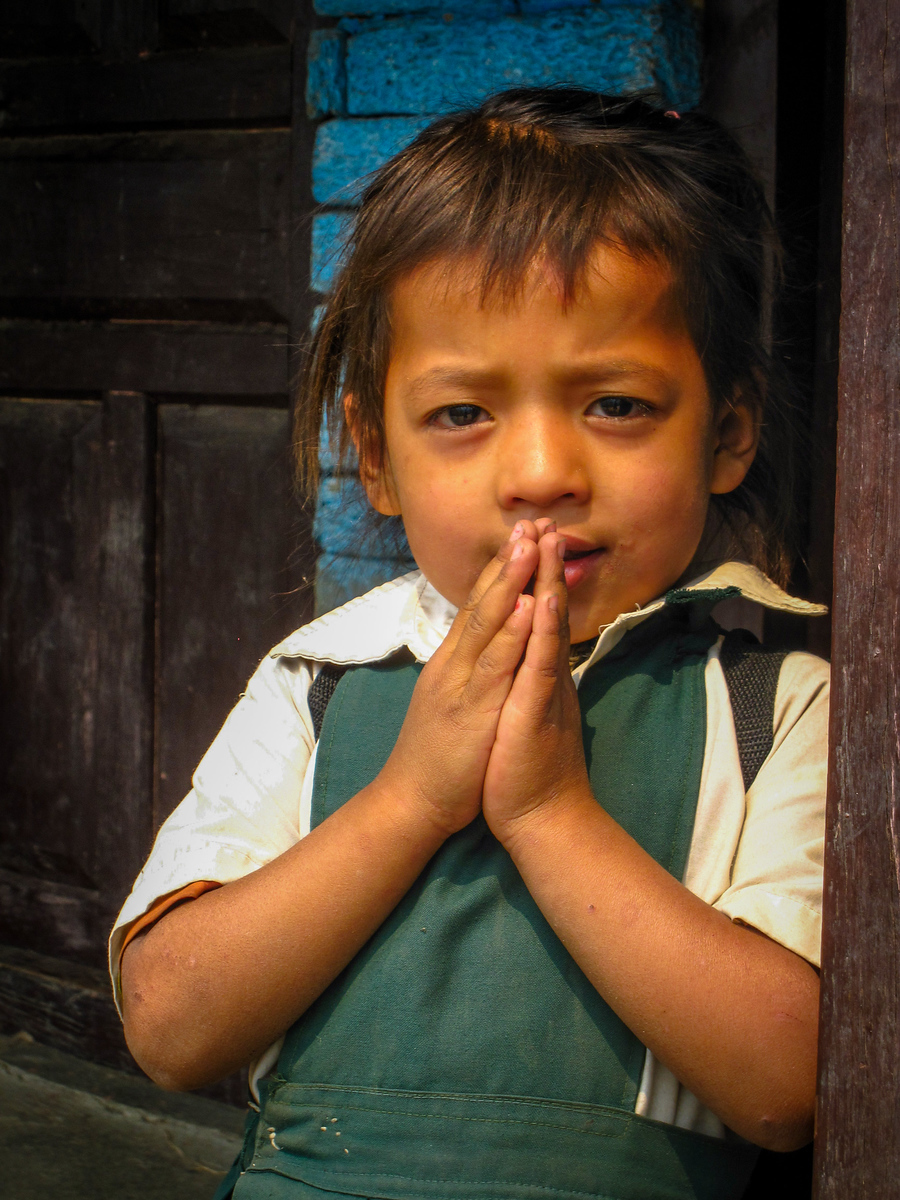 Another young girl giving us a namaste from her doorway young nepali girl on our trek