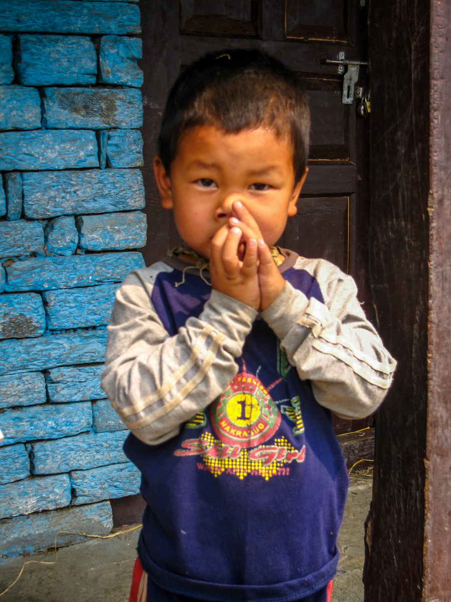 A young nepali boy on our trek sneaking in a nose picking while he greeted us! nepali boy